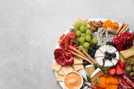 Assorted appetizers served on light gray table, top view. Space for textの写真素材