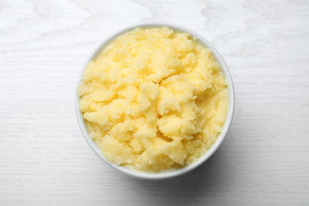 Bowl of Ghee butter on white wooden table, top viewの写真素材