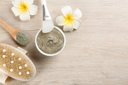 Flat lay composition with cosmetic product on light wooden background, space for text. Spa body wrapsの写真素材