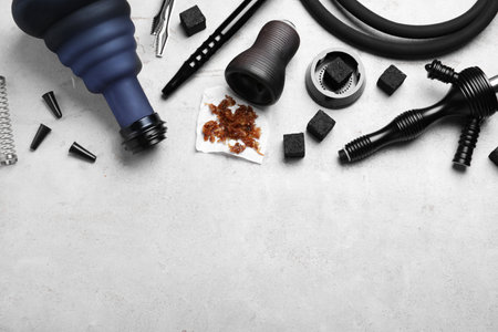 Flat lay composition with parts of hookah on light gray table, space for text