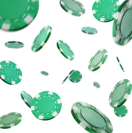 Green casino chips falling on white backgroundの写真素材