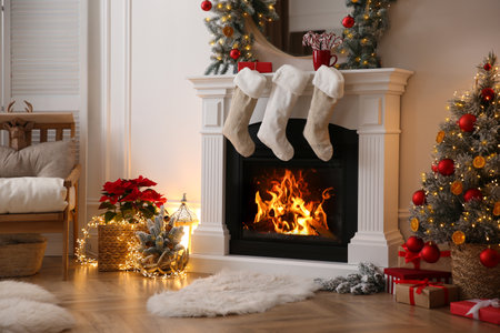 Fireplace with Christmas stockings in beautifully decorated living roomの写真素材