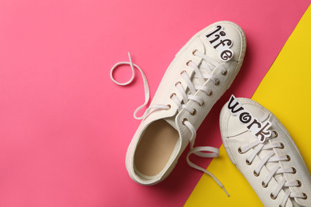 Stylish shoes on color background, flat lay with space for text. Life work balance conceptの写真素材