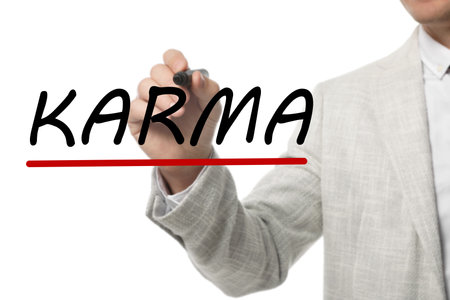 Man writing word KARMA on glass against white background, closeupの写真素材