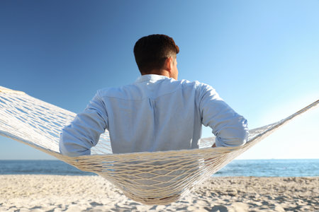 Man relaxing in hammock on the beach. summer holidaysの写真素材
