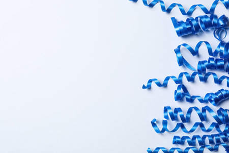Blue serpentine streamers on white background, top viewの写真素材