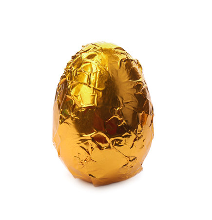 Chocolate egg wrapped in golden foil isolated on whiteの写真素材