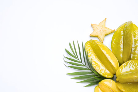 Delicious carambola fruits and leaves on white background, flat layの写真素材