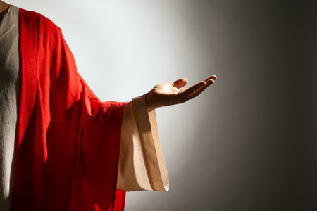 Jesus Christ reaching out his hand on gray background, closeup viewの写真素材