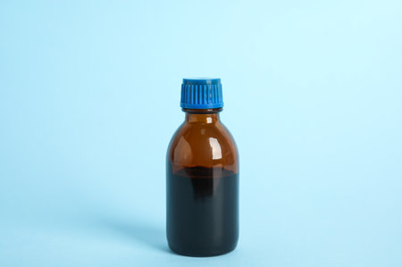Bottle of medical iodine on light blue backgroundの写真素材