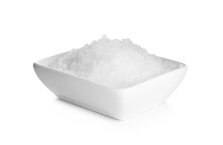 Natural salt in bowl isolated on whiteの写真素材