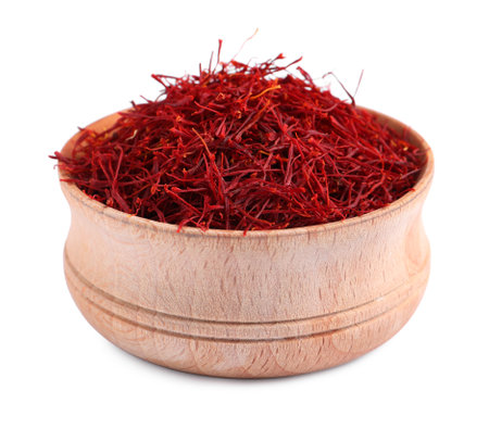 Dried saffron in wooden bowl isolated on whiteの写真素材