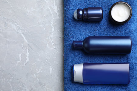 Flat lay composition with men's cosmetics on light gray marble background. Space for textの写真素材