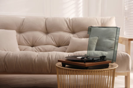 Stylish turntable with vinyl disc in living roomの写真素材