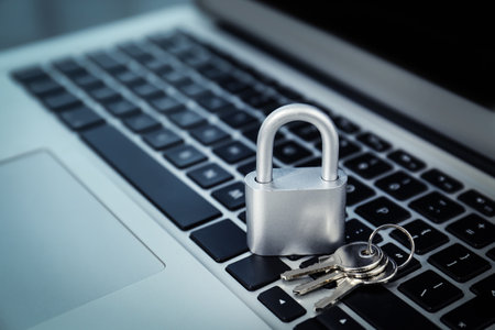Metal lock and keys on laptop, closeup. cyber security conceptの写真素材