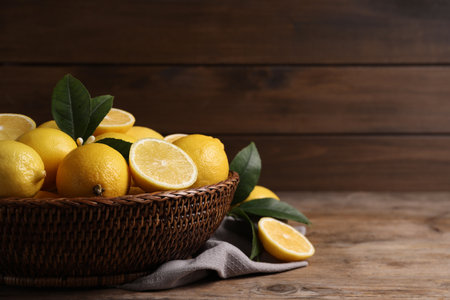 Many fresh ripe lemons on wooden table, closeup. Space for textの写真素材