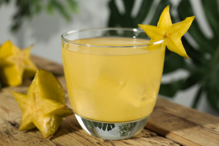 Delicious carambola juice in glass on wooden table, closeupの写真素材