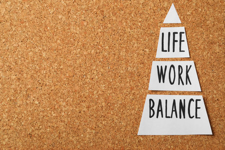 Paper sheets with words Life, Work, Balance on cork board, flat lay. Space for textの写真素材