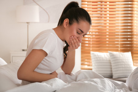 Young woman suffering from nausea at home. food poisoningの写真素材