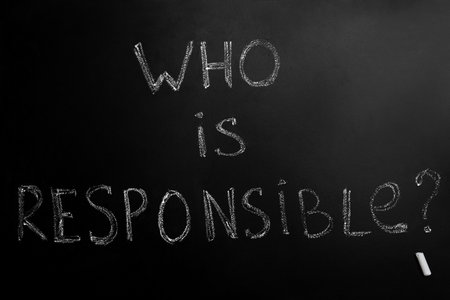 Question Who Is Responsible and chalk piece on black backgroundの写真素材
