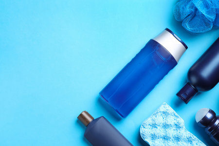 Flat lay composition with men's cosmetic products on light blue background. Space for textの写真素材