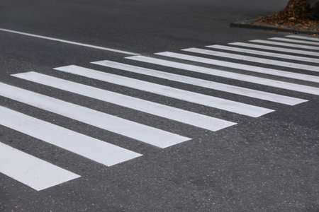 White pedestrian crossing on empty city streetの写真素材