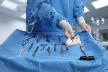 Nurse near table with different surgical instruments in operating room, closeupの写真素材