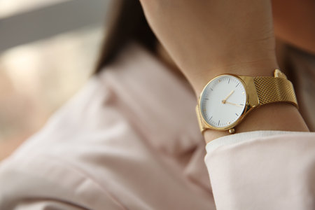 Woman with luxury wristwatch on blurred background, closeupの写真素材