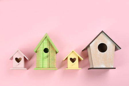 Collection of handmade bird houses on pink background, flat layの写真素材