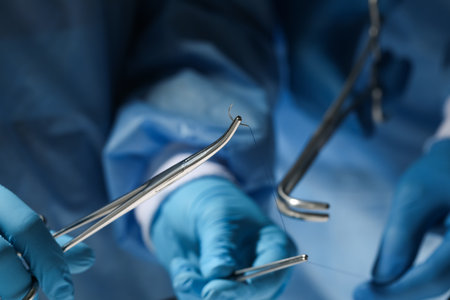 Professional surgeons with forceps and suture thread, closeup. medical equipmentの写真素材