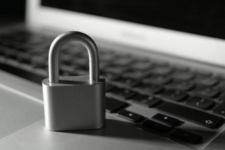 Metal lock on laptop, closeup. cyber security conceptの写真素材
