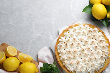 Flat lay composition with delicious lemon meringue pie on light gray table, space for textの写真素材