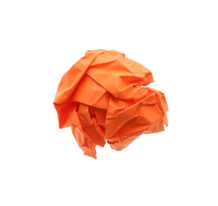 Crumpled sheet of orange paper isolated on white, top viewの写真素材