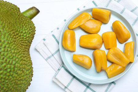 Delicious exotic jackfruit and bulbs on white table, flat layの写真素材
