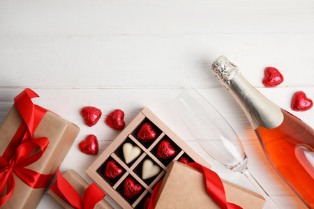 Flat lay composition with heart shaped chocolate candies on white wooden table, space for text. happy valentines dayの写真素材