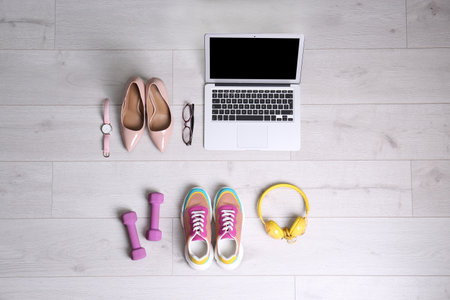 Flat lay composition of business items with sport accessories on white wooden background. Life and work balance conceptの写真素材
