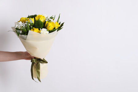 Woman with bouquet of beautiful tulips on white background, closeup. Space for textの写真素材