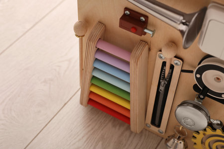 Busy board house on floor indoors, closeup view space for text. baby sensory toyの写真素材