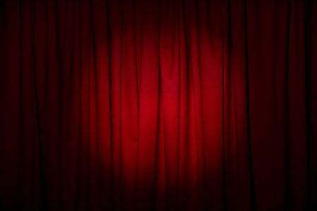 Closed elegant red front curtains as backgroundの写真素材