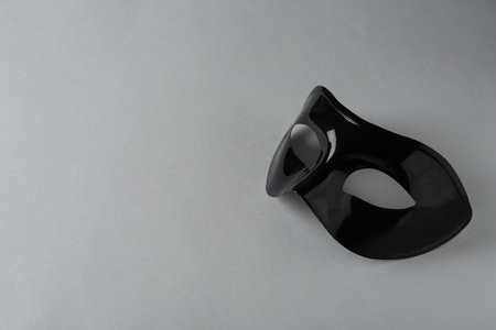 Black theater mask on gray background, space for textの写真素材