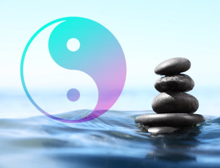 Stack of stones in water and Ying Yang symbol. Feng Shui philosophyの写真素材