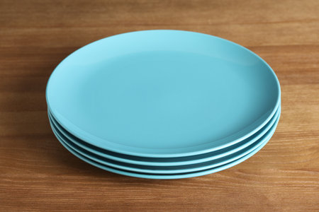 Elegant new empty plates on wooden tableの写真素材