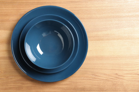 New empty dishes on wooden table, top view. Space for textの写真素材