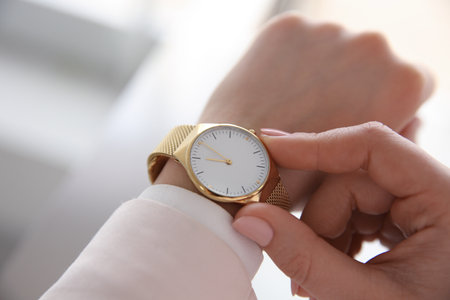 Woman with luxury wristwatch on blurred background, closeupの写真素材
