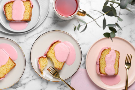 Delicious cake with pink glaze served on white marble table, flat layの写真素材