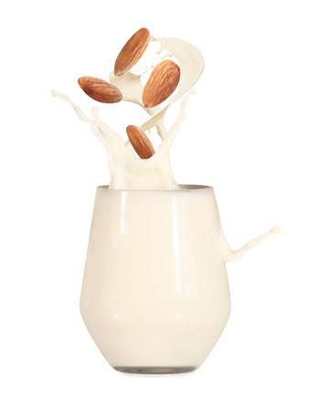 Delicious almond milk and nuts on white backgroundの写真素材
