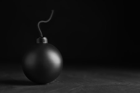 Sphere shaped bomb with burning fuse on black background. Space for textの写真素材