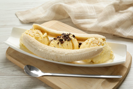 Delicious banana split ice cream with toppings on white wooden table , closeupの写真素材