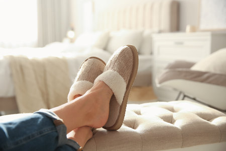 Woman wearing soft comfortable slippers at home, closeupの写真素材