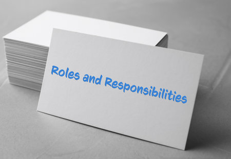 Sheet of paper with text Roles and Responsibilities on gray stone tableの写真素材